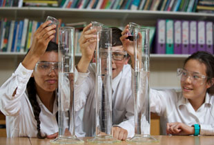 Three Kimbolton School Pupils Performing a Chemistry Experiment Mixing Liquids in Large Test Tubes