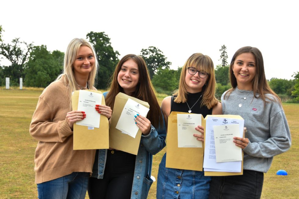 Students smiling together having received their A Level grades